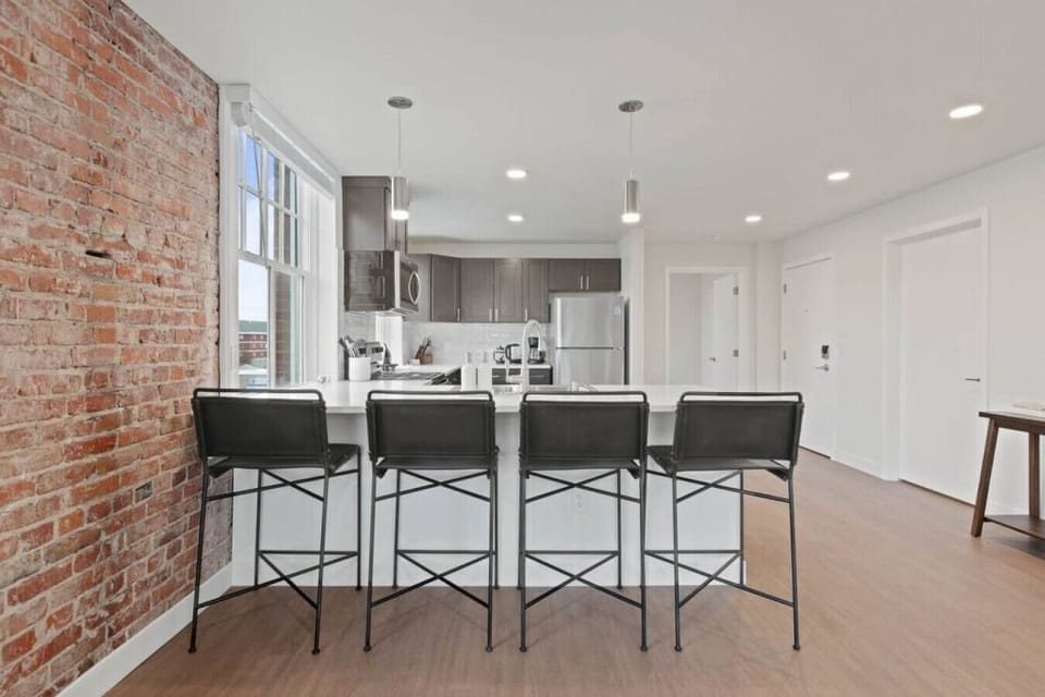 Sleek, fully stocked kitchen with high-end appliances—perfect for home-cooked meals or morning coffee.