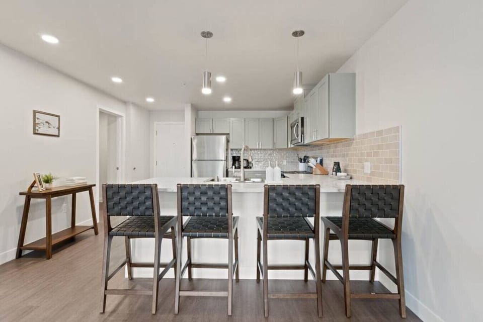 Sleek, fully stocked kitchen with high-end appliances—perfect for home-cooked meals or morning coffee.