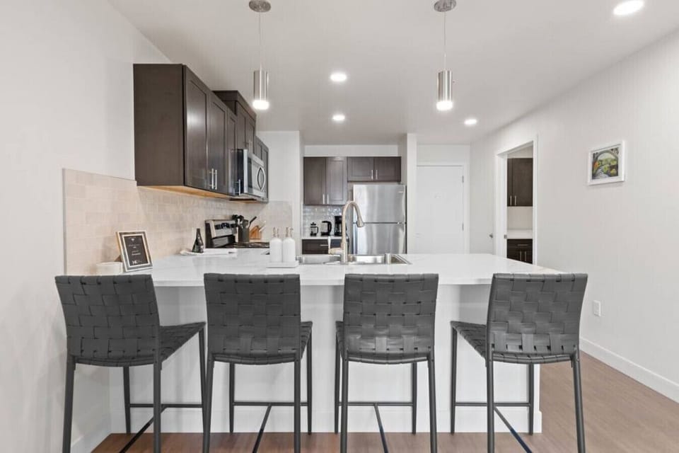 Sleek, fully stocked kitchen with high-end appliances—perfect for home-cooked meals or morning coffee.