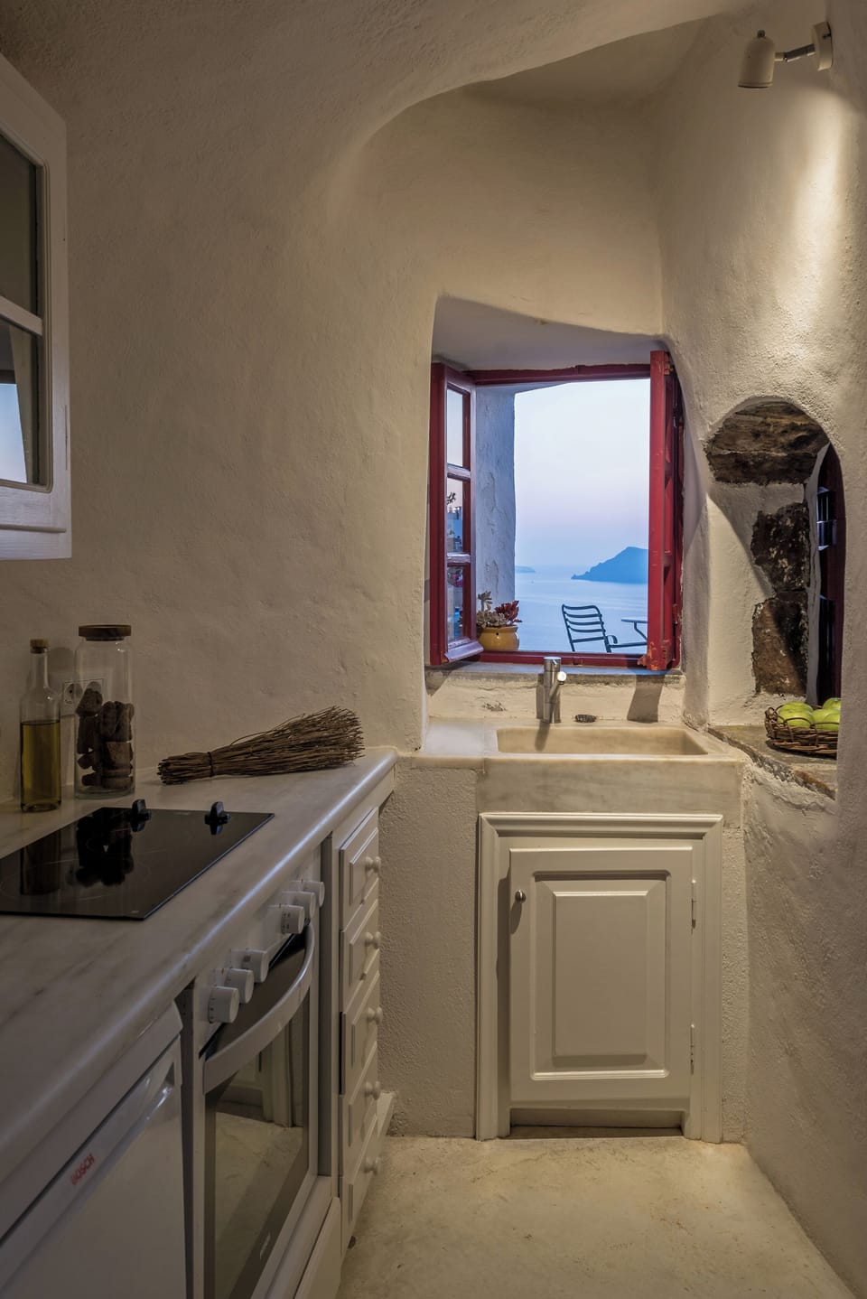 Cook local flavors in a charming kitchen with sea-view window.