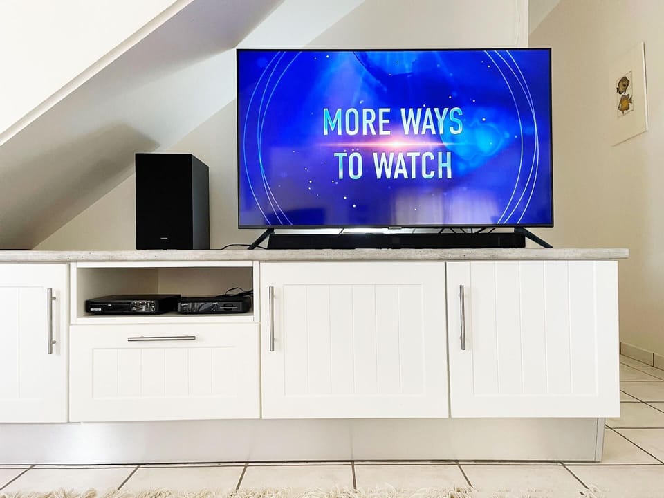 50" Smart TV with streaming channels, DVD and Soundbar.