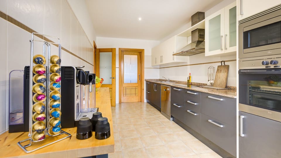 Kitchen with fridge freezer, microwave, oven, hob, dishwasher, Nespresso machine