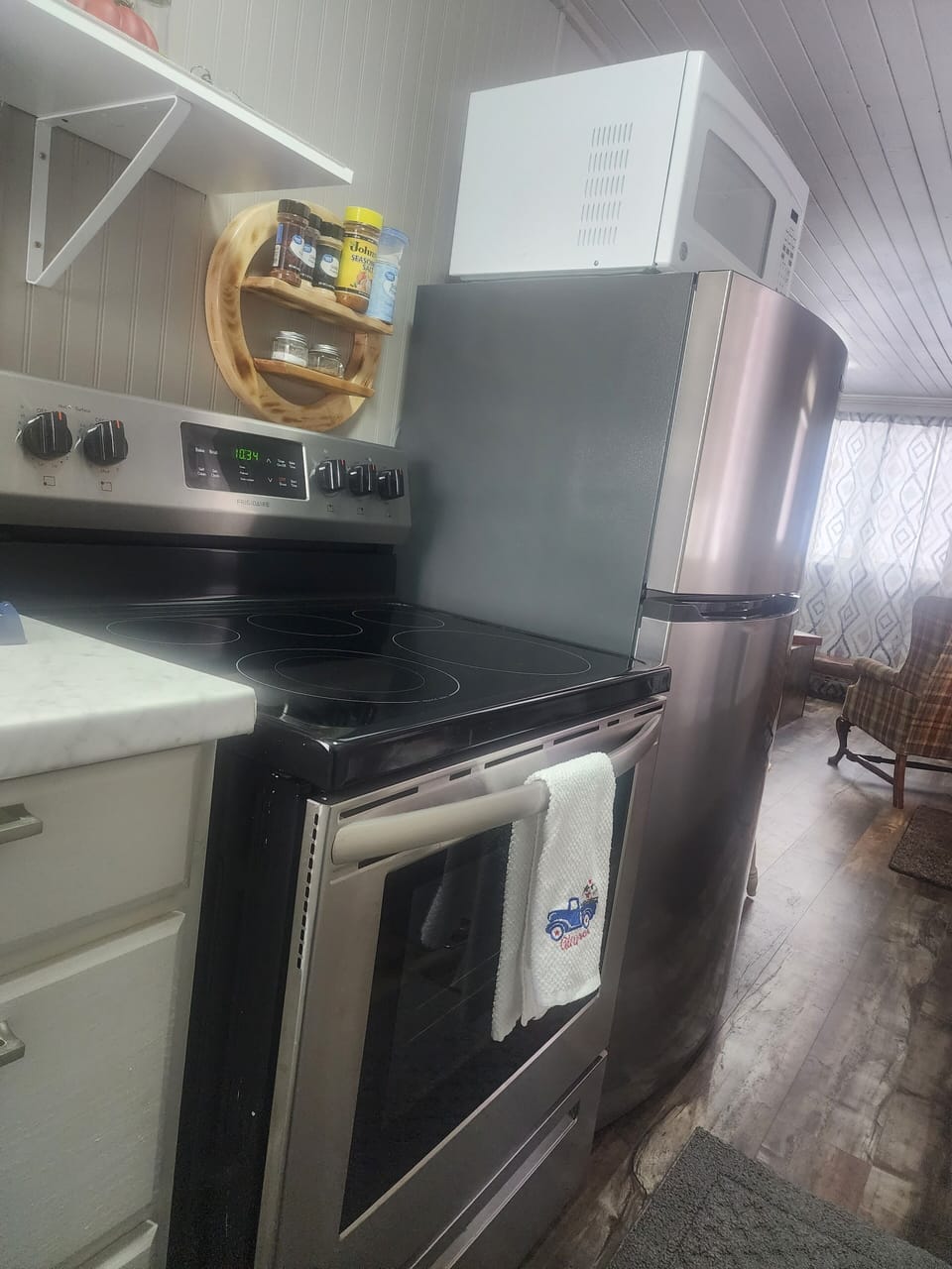 kitchen with full stove, fridge, microwave, kerig and small crock pot.