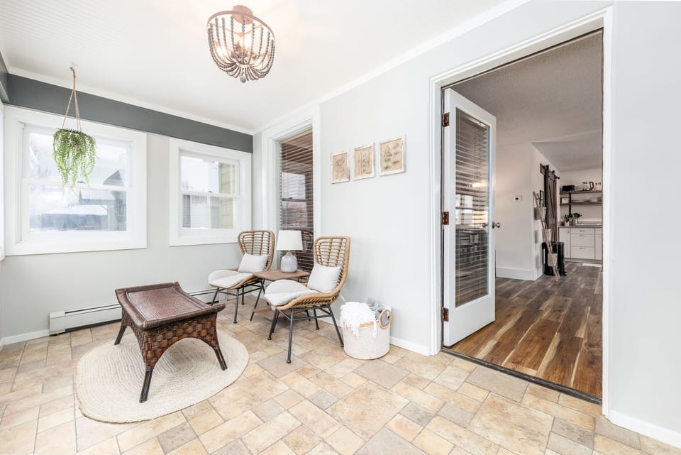 Enter through a comfortable enclosed porch