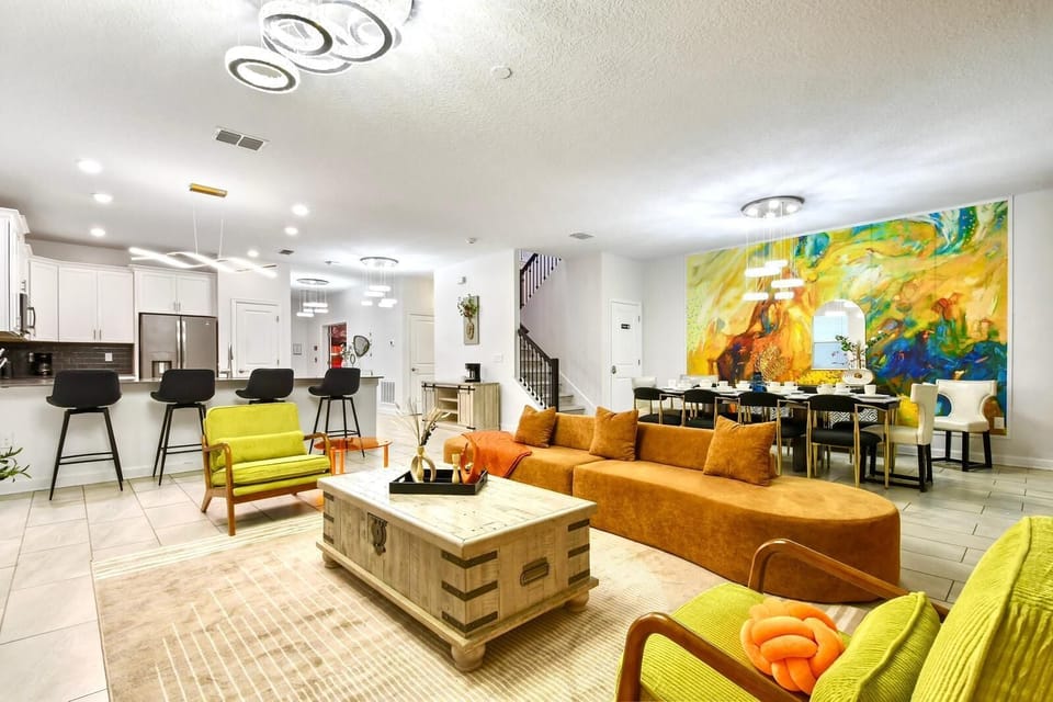 Spacious open-concept home with modern decor, vibrant accents, and cozy seating.