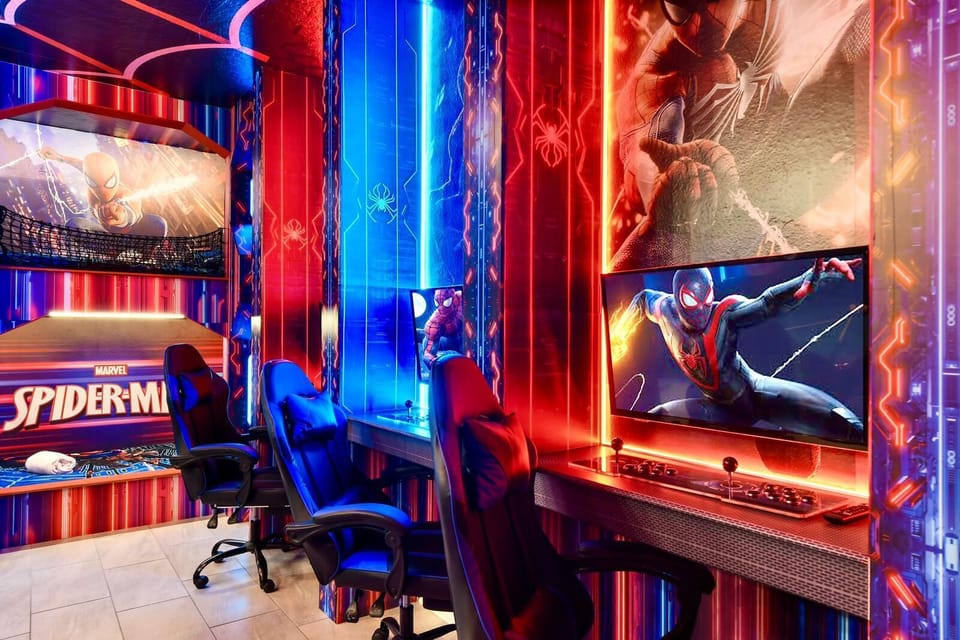 Ultimate Spider-Man gaming room with LED lighting, dual setups, and themed décor.