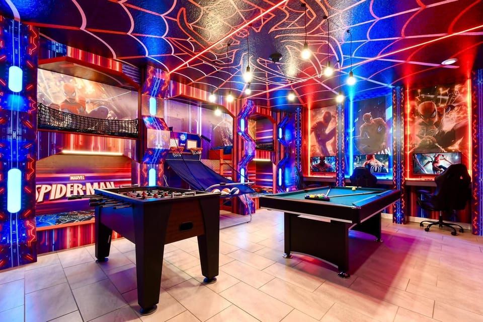 Epic Spider-Man game room with arcade, pool, foosball, bunk beds, and gaming setup.