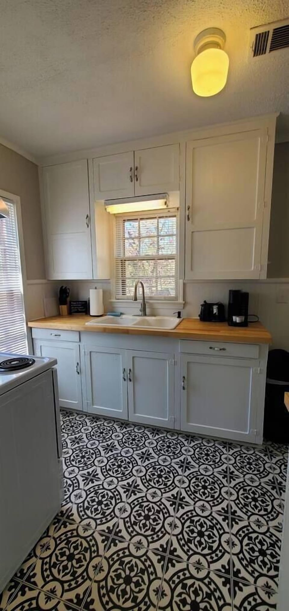 Bright, fully stocked kitchen with essentials including a stove, toaster, knives, and cutting boards. Perfect for cooking meals or prepping quick snacks during your stay.