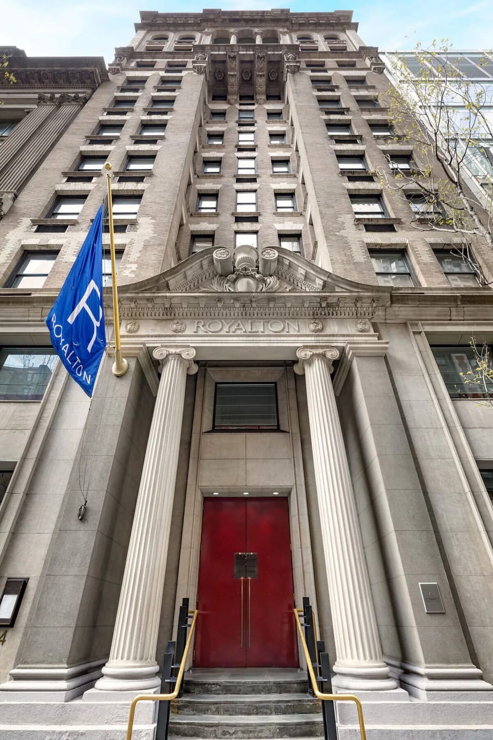 Step into a grand entrance framed by classic city architecture.