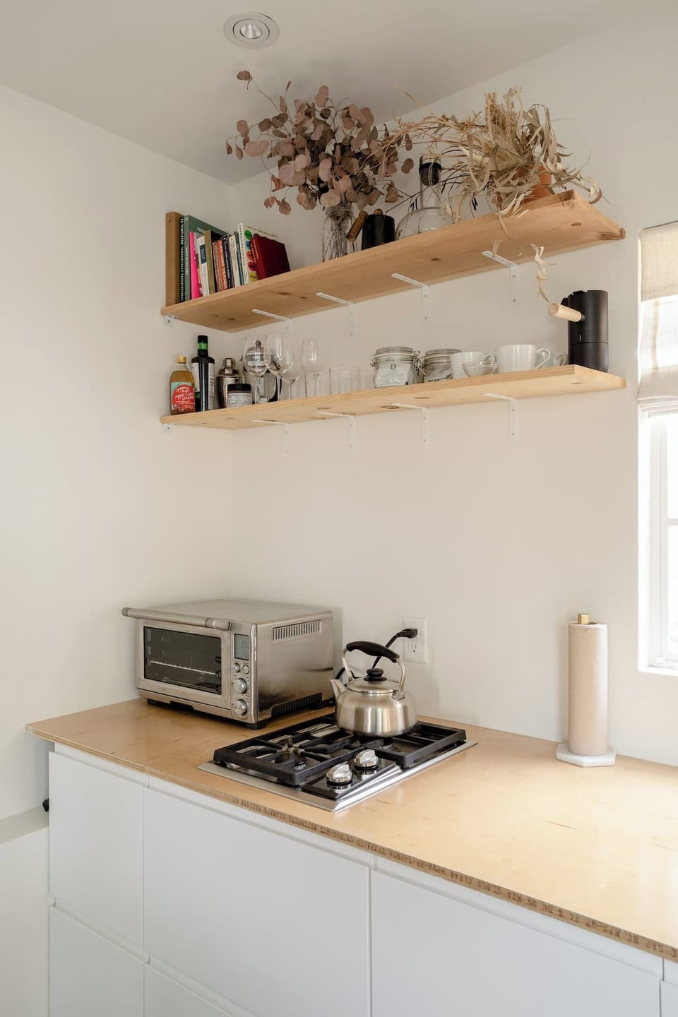 Kitchenette with two burner gas stove and mini oven.