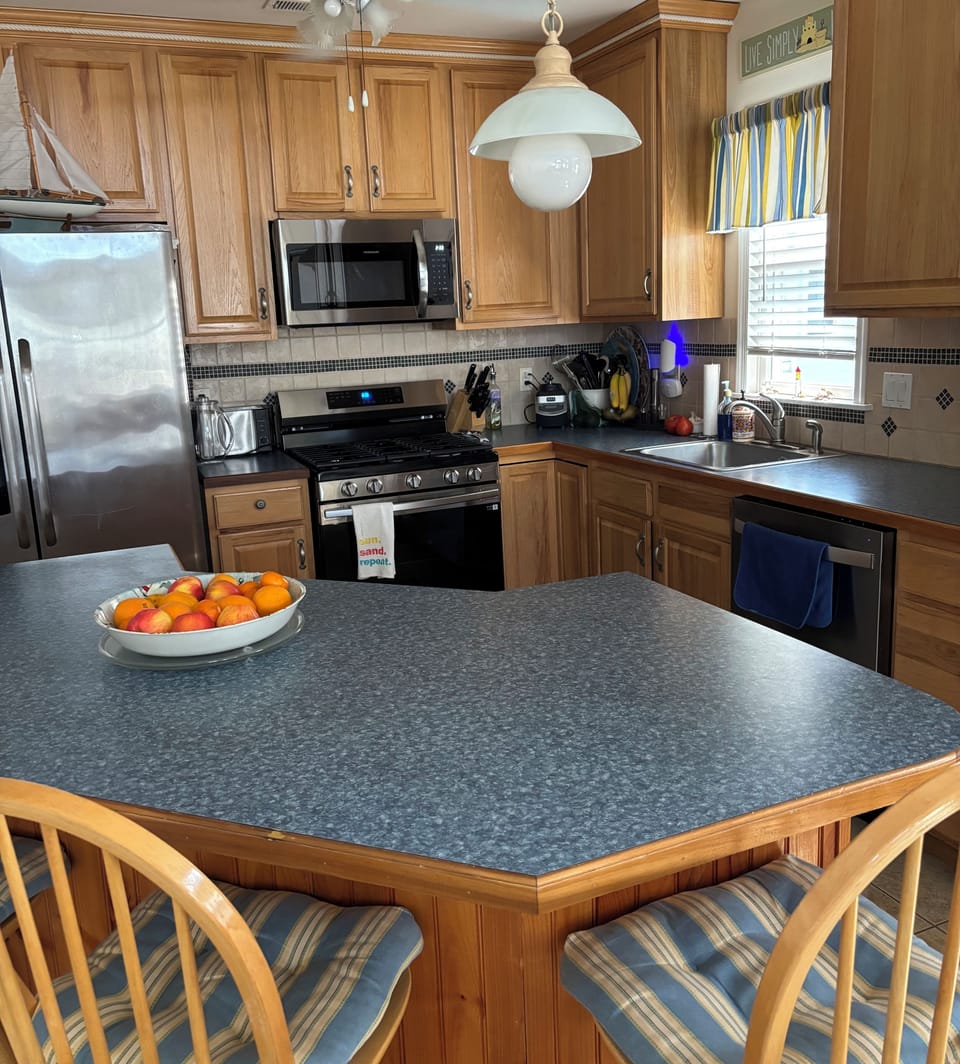 Beautiful kitchen with brand, new microwave, stove, and dishwasher.