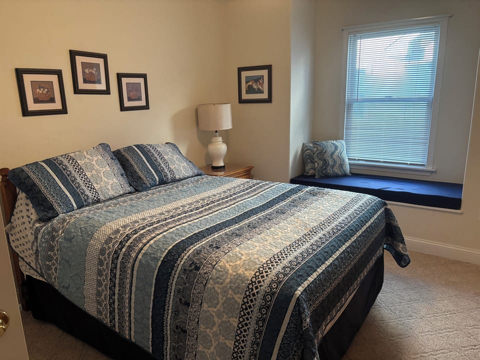 Middle floor bedroom with a queen size bed.