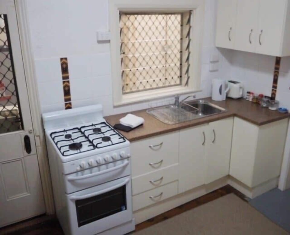 Kitchen with full sized stove and microwave