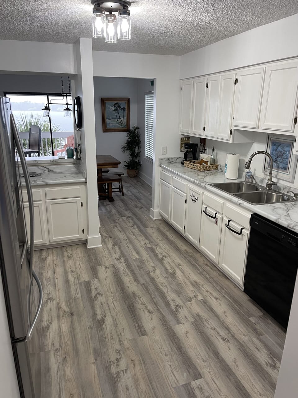 View of the kitchen.  Dishwasher, large refrigerator, and coffee maker.  