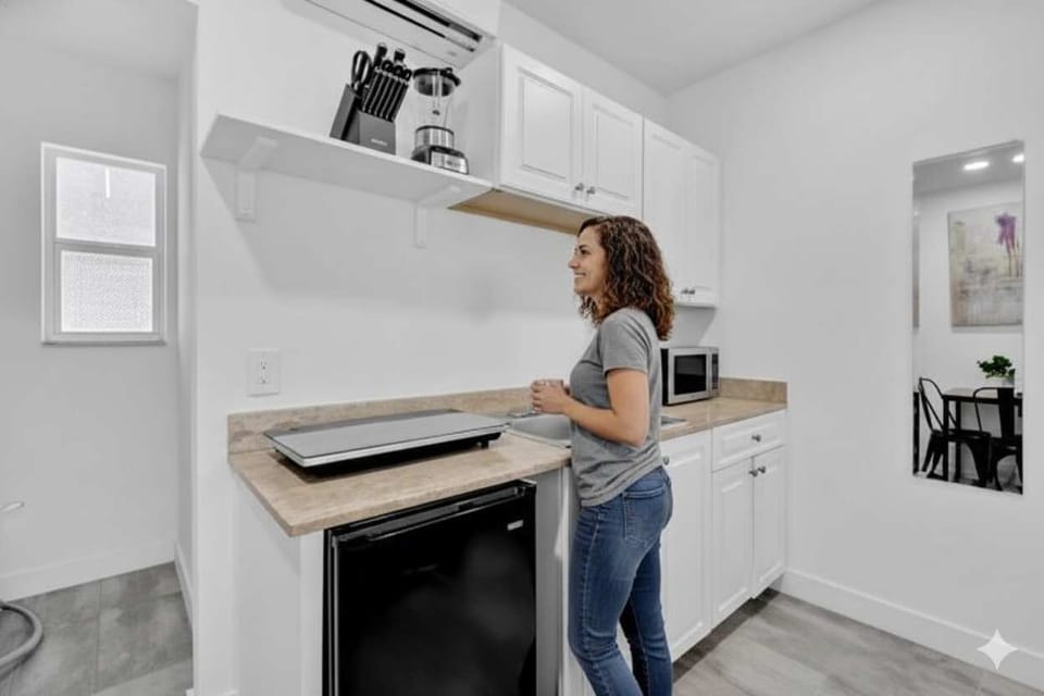   
Compact kitchen with modern appliances, natural light, and cozy dining space—perfect for long stays or travelers who love cooking in their Airbnb.