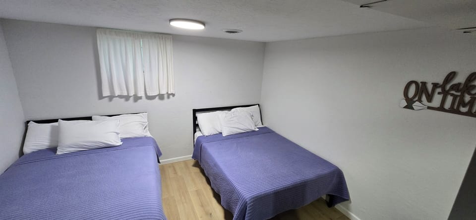 Open concept bedroom in basement. 2 full size beds.