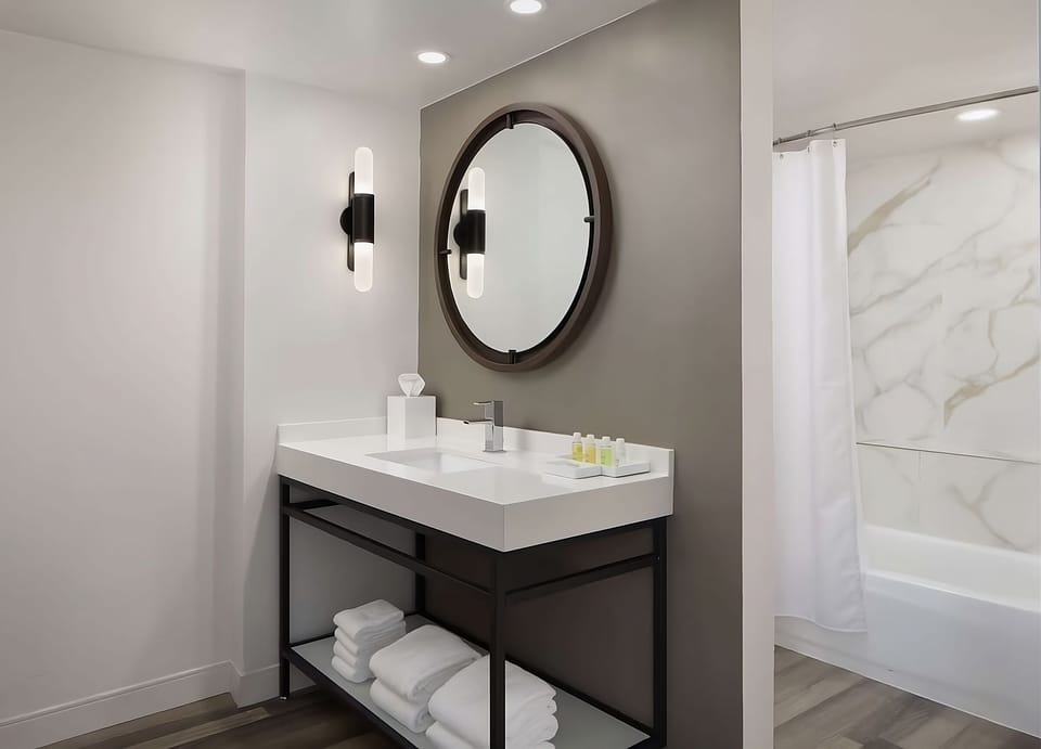 Start the day at a glowing vanity with fresh towels.