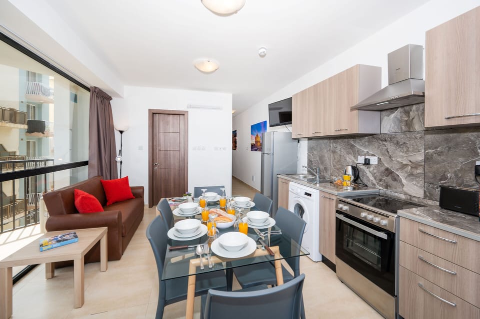 Kitchen, dining area and sofa bed