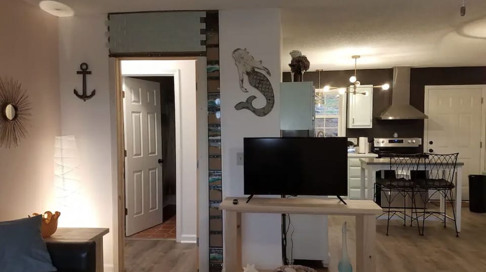 Kitchen and living room with entrance into the 2 bedroom/one bath private suite