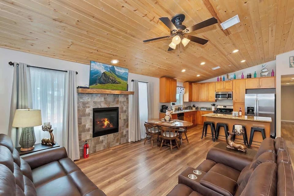 Open concept kitchen, living room with fireplace, TV and ceiling fan (great in summer!)