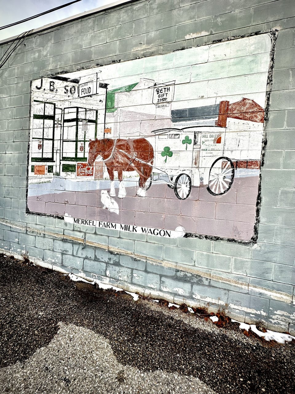 Mural of the Hill Dale Dairy Wagon on the side of a building downtown