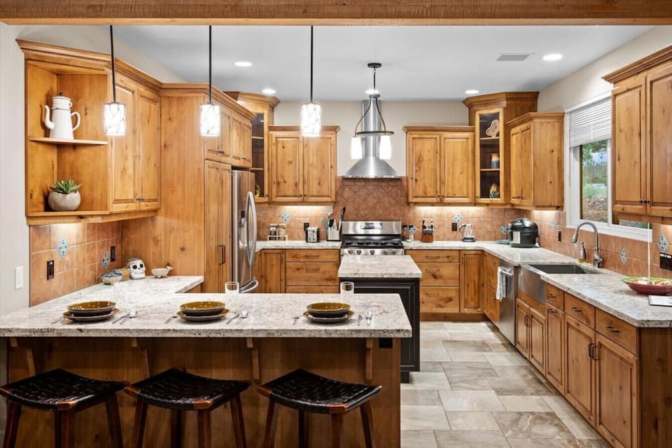 A fully equipped kitchen with island as well as counter bar seating makes this a wonderful space for preparing meals.