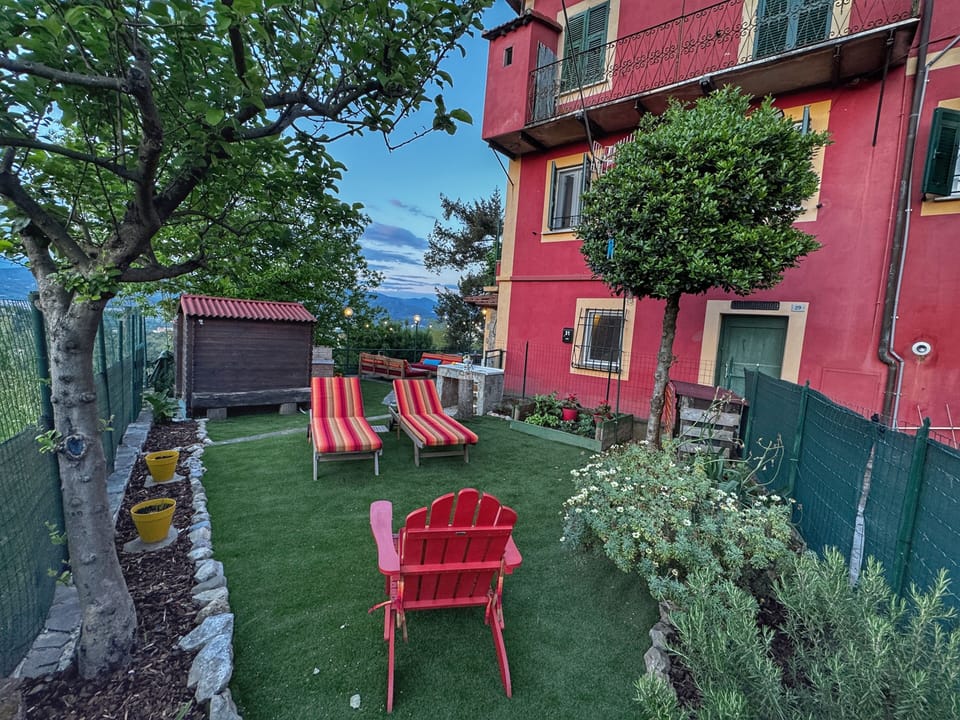 Private yard/garden area with sun loungers & adirondack chair for guests to use