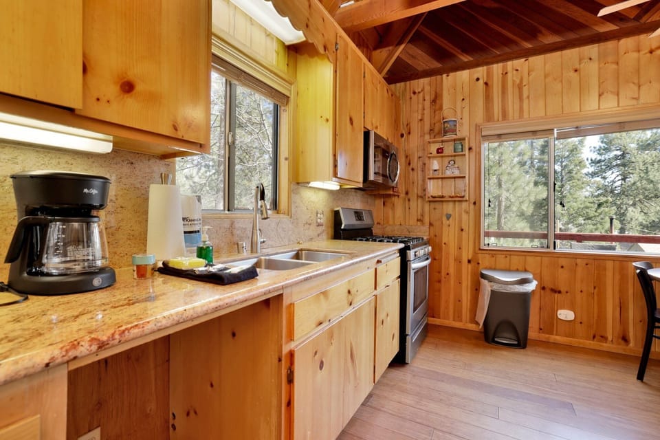 Fully equipped cabin kitchen with ample cabinetry, stove, fridge, microwave, and coffee maker—perfect for cooking meals, morning coffee, and feeling right at home on your stay.