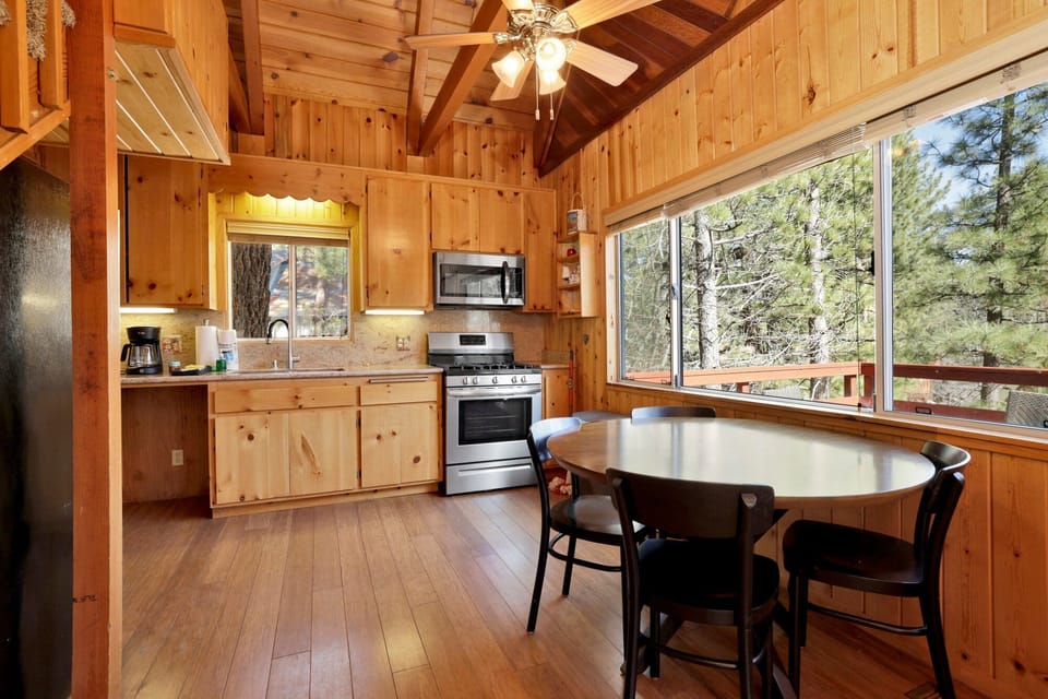 Fully equipped cabin kitchen with ample cabinetry, stove, fridge, microwave, and coffee maker—perfect for cooking meals, morning coffee, and feeling right at home on your stay.
