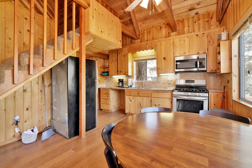 Fully equipped cabin kitchen with ample cabinetry, stove, fridge, microwave, and coffee maker—perfect for cooking meals, morning coffee, and feeling right at home on your stay.
