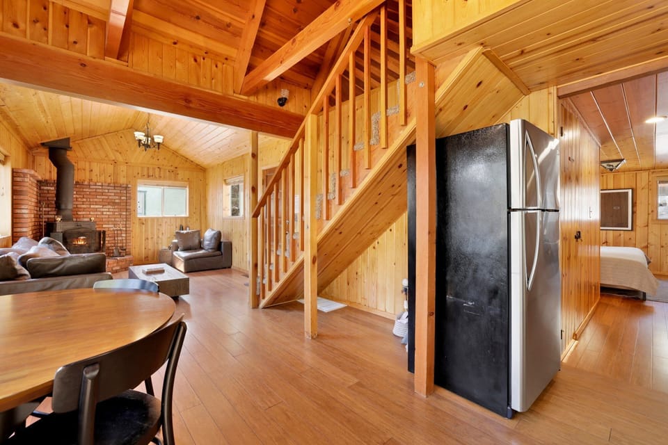 Fully equipped cabin kitchen with ample cabinetry, stove, fridge, microwave, and coffee maker—perfect for cooking meals, morning coffee, and feeling right at home on your stay.