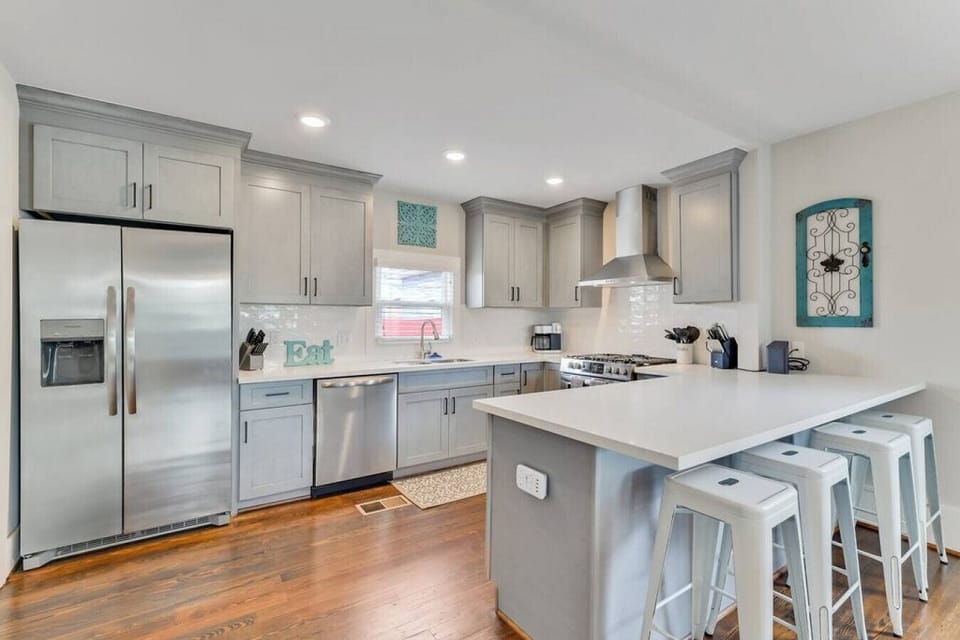 Sleek | Modern kitchen | Stainless steel appliances | Bar seating