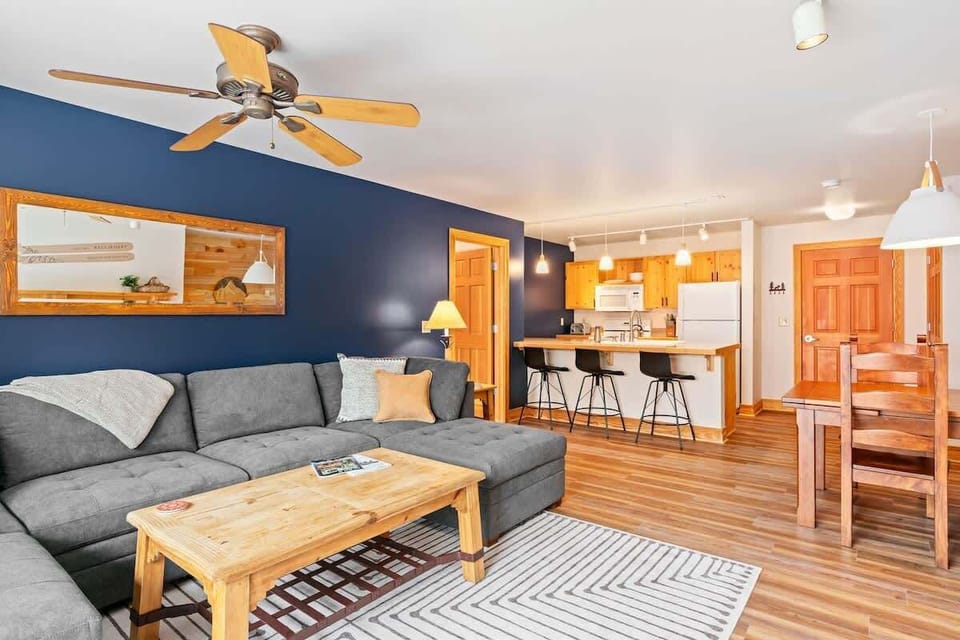 Living & kitchen area w/ an oversized couch to keep large groups comfortable.