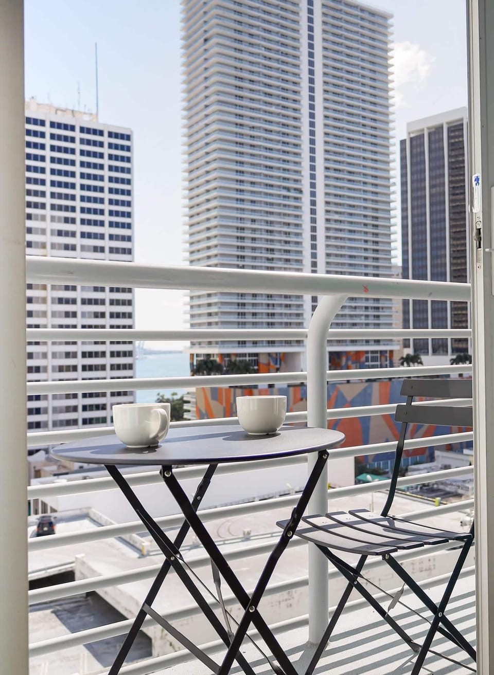 Unwind at Our Terrace, Complete with a Small Coffee Table. Enjoy Stunning Views of the Building and the Serene Beach. Your Perfect Spot for Relaxation and Scenic Delights.