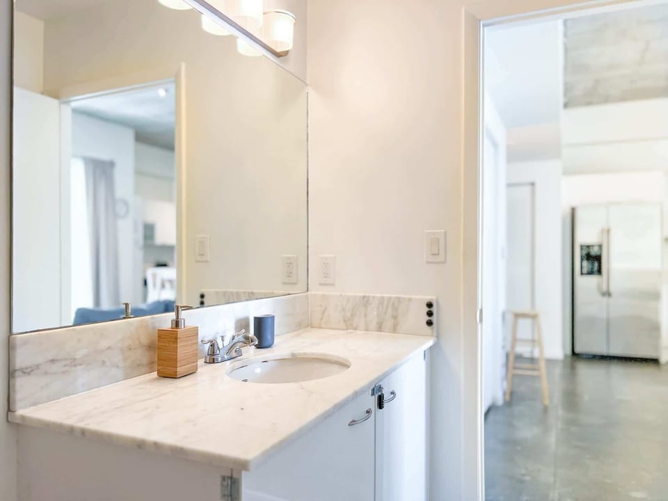 Our Sink with a Stylish Cabinet and Mirror, Creating a Chic and Functional Corner for Your Daily Routine.