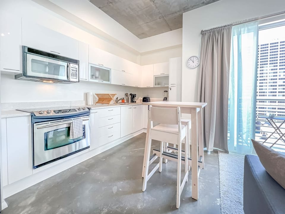 A good for Two Dining Table Nestled Near the Kitchen, Inviting You to Enjoy Delicious Meals in a Cozy Setting.