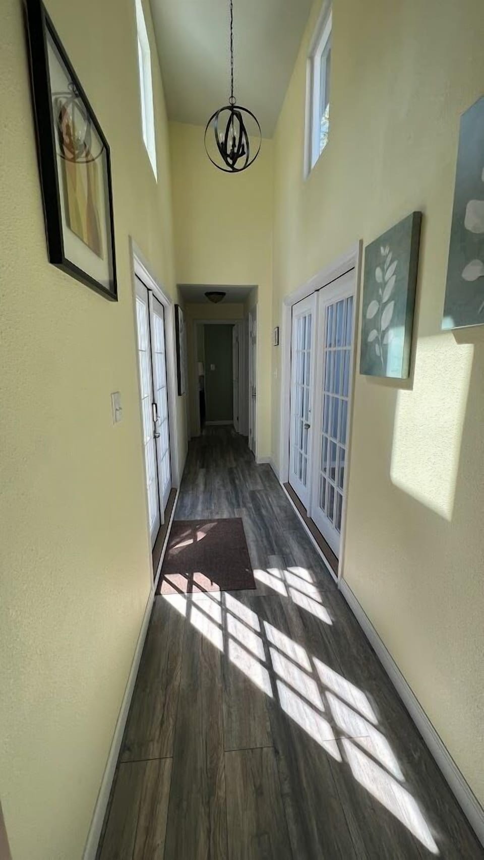 A light, soaring hallway links the living area with the bedrooms.