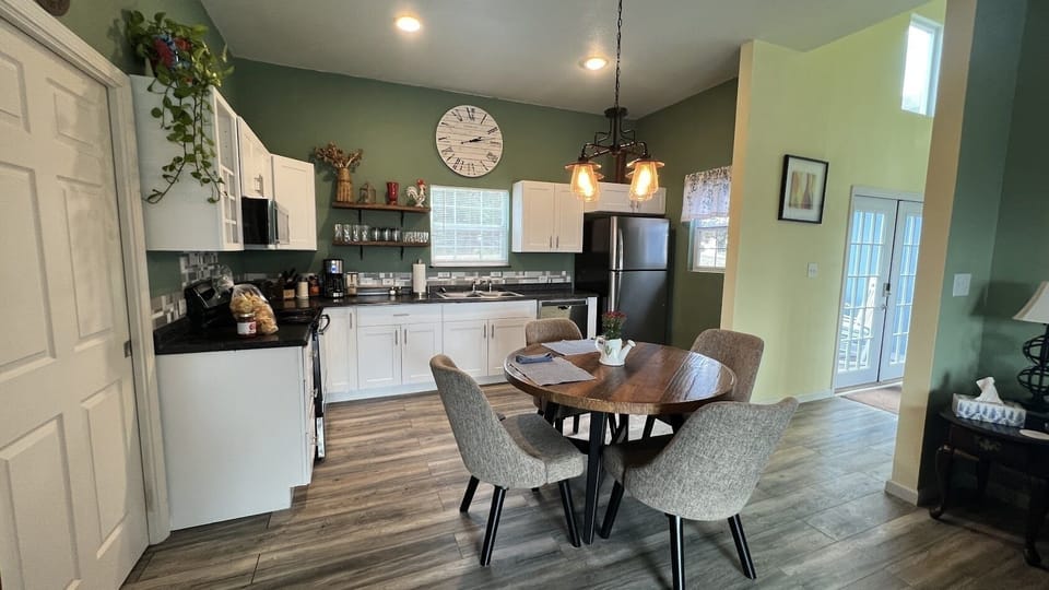 A fully equipped kitchen with a full sized refrigerator.
