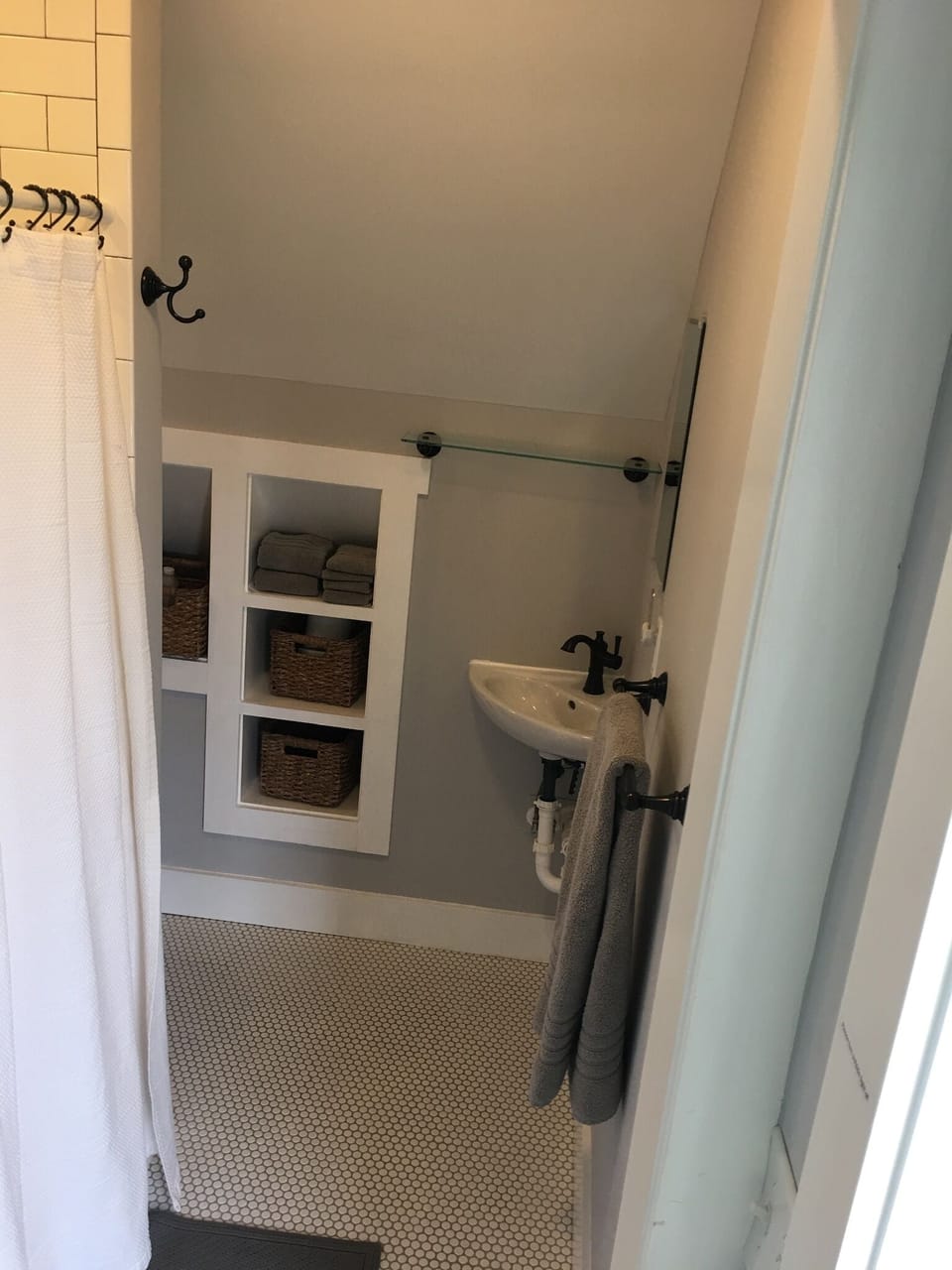 Bathroom includes a shower, sink and toilet.