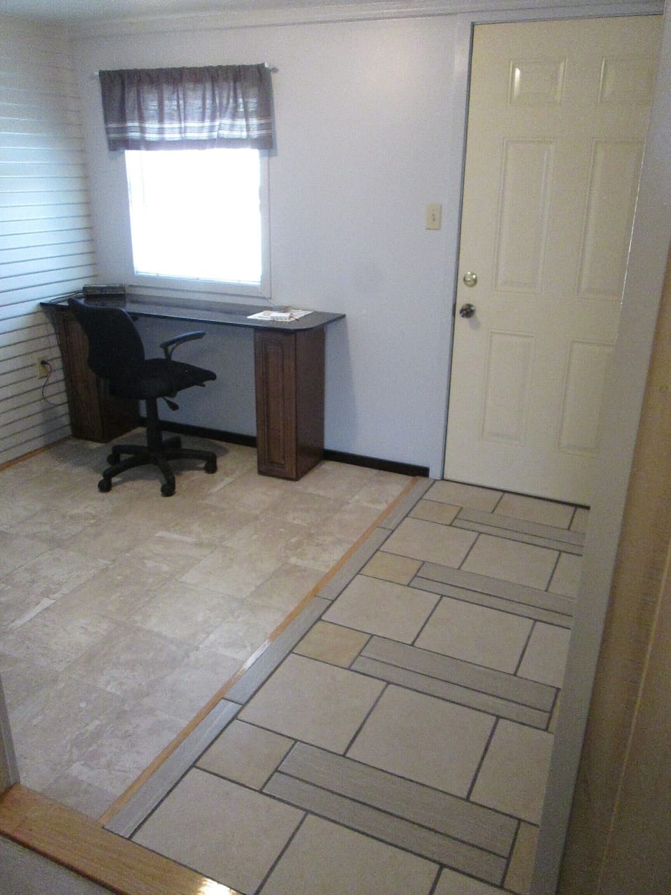 Office area has easy care tile entryway to backyard