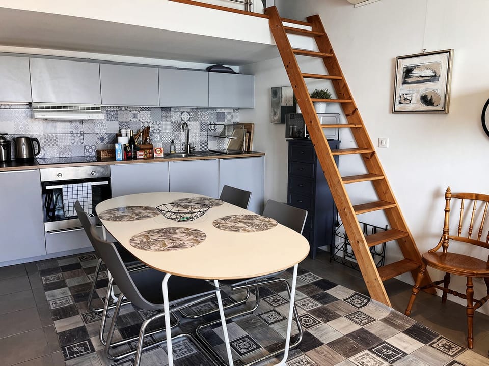 The kitchen with the ladder up to the mezzanine where one person can sleep.