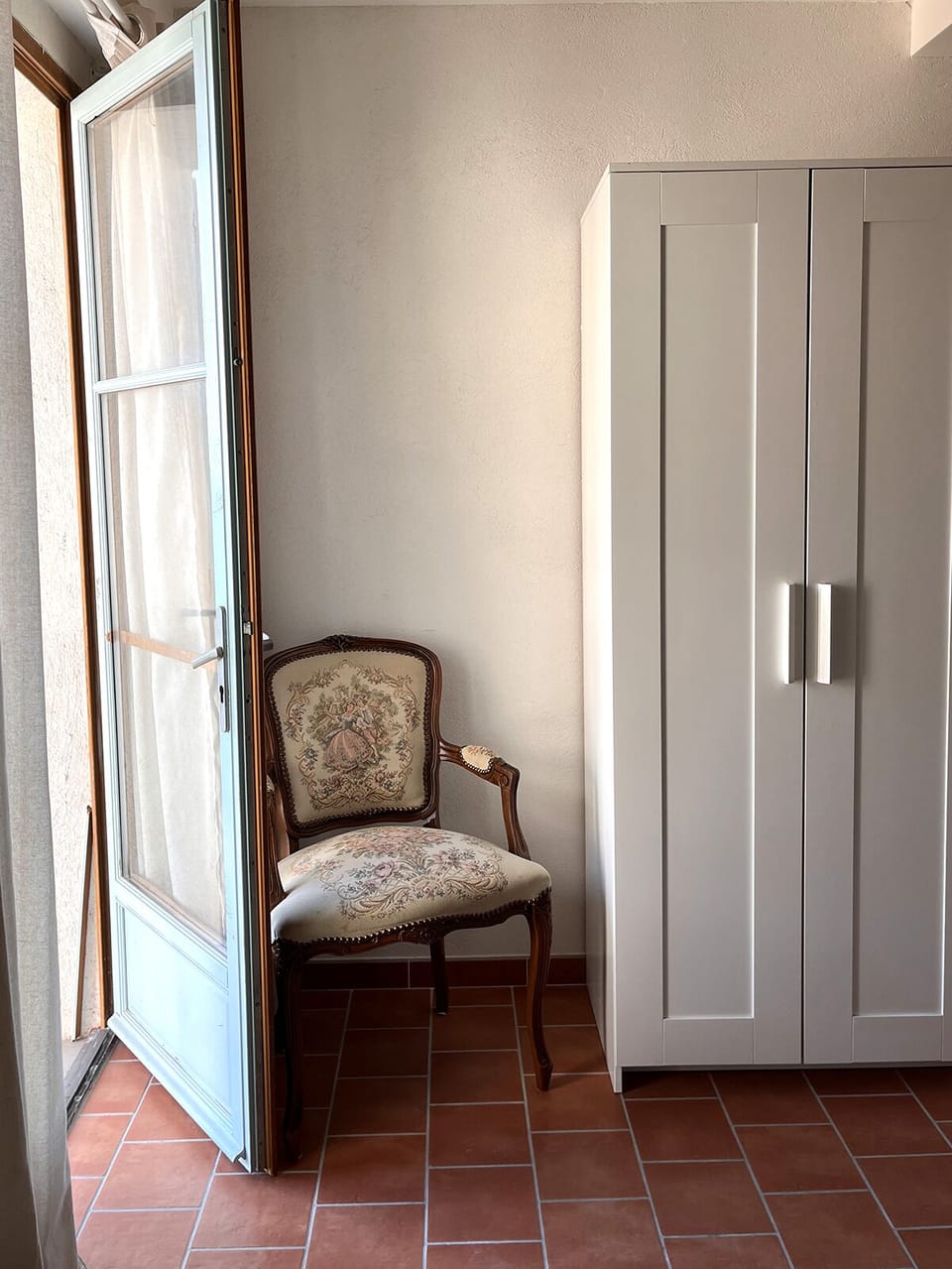 The second bedroom with a double bed and a bathroom area