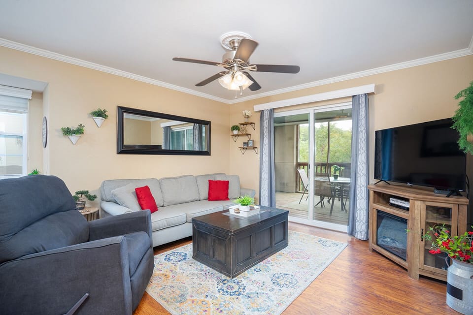 Condo 1 Living Room: Make lasting memories with loved ones in this inviting condo - gather around the table for a friendly board game competition or snuggle up and enjoy a movie night on the TV in the evenings.