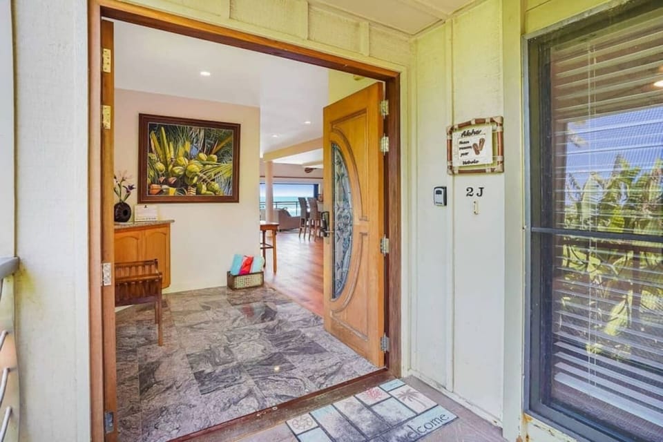 Private unit entryway offering a warm welcome and coastal charm.