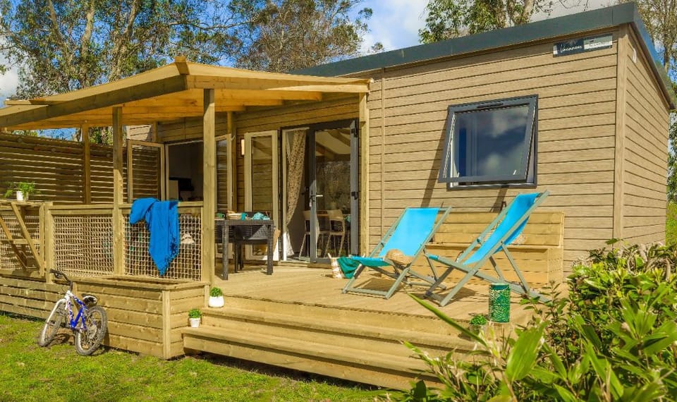 Enjoy outdoor living on this charming deck, complete with cozy lounge chairs for ultimate relaxation.