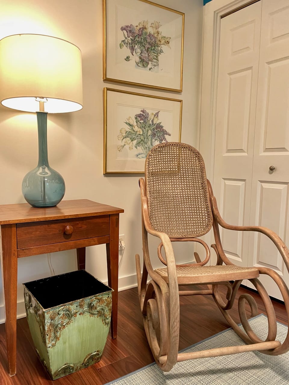 Vintage Thonet rocker  in front of watercolors by Maine artist Jo Spiller
