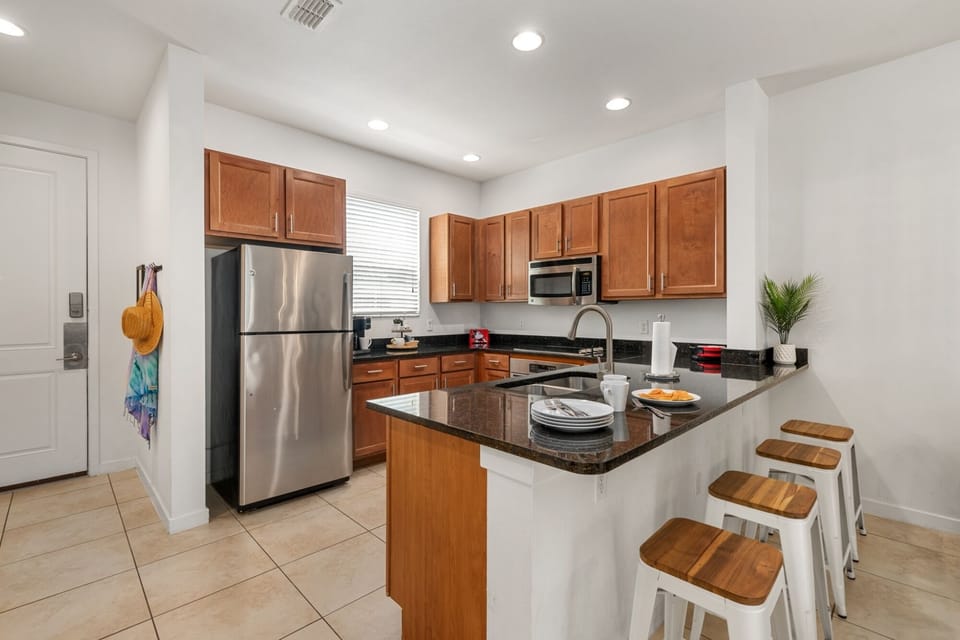 Whip up meals or Disney-themed snacks in this modern kitchen with granite countertops and full-size appliances.