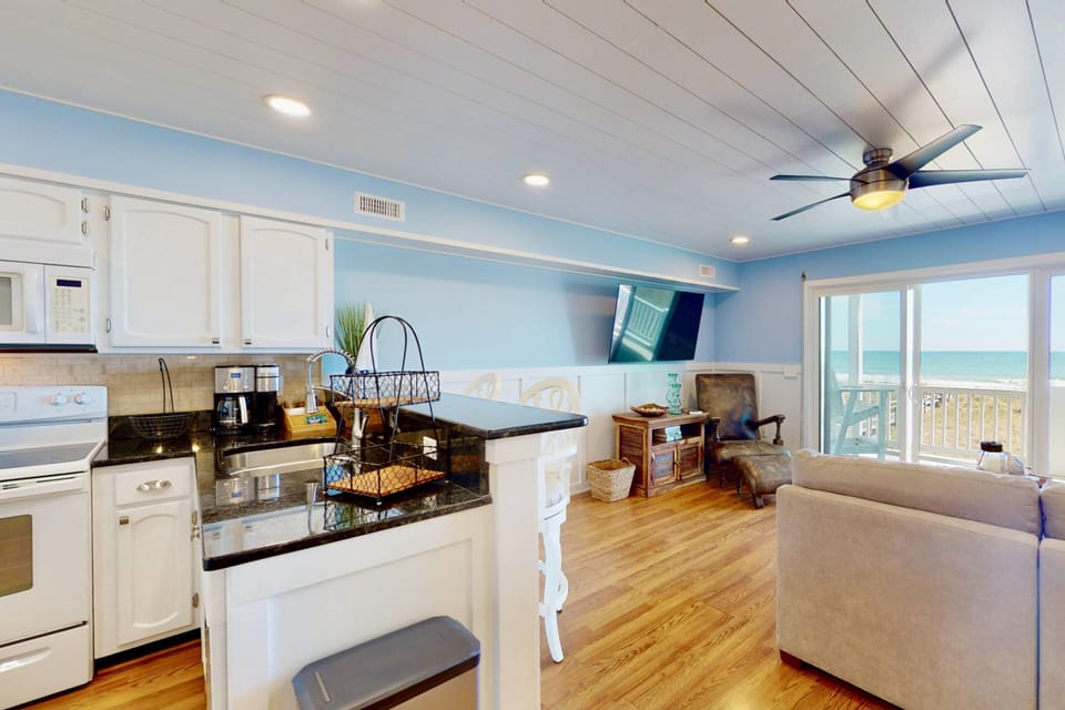 Enjoy the light & bright living area featuring a custom ceiling