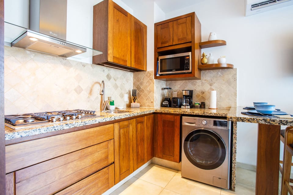 Kitchen amenities include a stove, full-size refrigerator, microwave and coffee maker