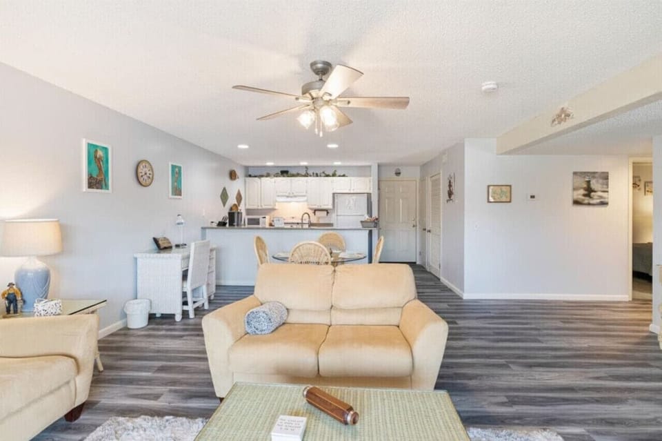 Living Room facing front door entry and kitchen